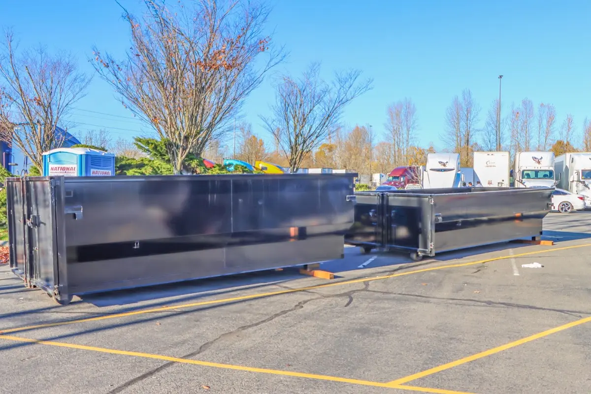 Professional dumpster rental service with roll-off container on residential driveway in Bonita